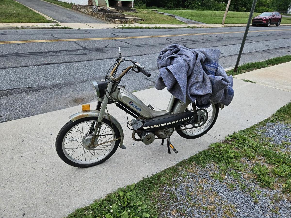 Bermuda moped on sidewalk with blanket